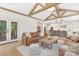 Open-concept living room with exposed wood beams, hardwood floors, and modern furnishings at 102 Antioch Plantation Dr # 18, Matthews, NC 28104