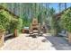 A brick patio with an outdoor kitchen, fireplace, pizza oven, and seating area, perfect for entertaining at 102 Antioch Plantation Dr # 18, Matthews, NC 28104