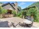 Outdoor living space with brick patio, pergola covered in flowering vines, and comfortable seating at 102 Antioch Plantation Dr # 18, Matthews, NC 28104