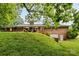 The expansive backyard features a brick exterior with a covered patio and lush greenery at 1081 Long Dr, Newton, NC 28658