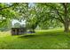 Large backyard with mature trees, trampoline, and play structure, offering recreational opportunities at 1081 Long Dr, Newton, NC 28658