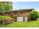 Backyard features a partial brick wall, a garage, and a grassy area, offering privacy and outdoor space at 1081 Long Dr, Newton, NC 28658