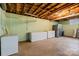 Spacious basement featuring painted walls, exposed ceiling, and multiple storage freezers at 1081 Long Dr, Newton, NC 28658