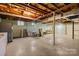 Large basement area with exposed ceiling, painted walls, and utility connections at 1081 Long Dr, Newton, NC 28658