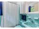 Cozy bathroom featuring blue tiles, a unique sink, and a functional shower-tub combo at 1081 Long Dr, Newton, NC 28658