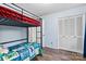 This bedroom has a bunk bed set with white doors and matching wooden floors at 1081 Long Dr, Newton, NC 28658