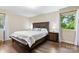 This bedroom features a wooden bed frame, hardwood floors, and large windows for natural light at 1081 Long Dr, Newton, NC 28658