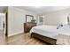Bedroom with hardwood floors, dresser, and a large window offering a view of the outdoors at 1081 Long Dr, Newton, NC 28658