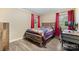This bedroom offers a rustic wooden bed frame, hardwood floors, and a dedicated desk area at 1081 Long Dr, Newton, NC 28658