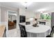 Bright kitchen with white cabinets, stainless appliances, and a breakfast nook overlooking the living area at 1081 Long Dr, Newton, NC 28658