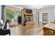 Inviting living room with hardwood floors, a brick fireplace, and sliding glass doors to the patio at 1081 Long Dr, Newton, NC 28658
