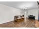 The spacious living room features hardwood floors, a futon, and a piano, offering comfort and entertainment at 1081 Long Dr, Newton, NC 28658