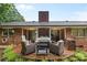 Relaxing brick patio with comfortable seating, grill, and a charming outdoor fireplace at 1081 Long Dr, Newton, NC 28658