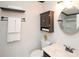 Elegant bathroom with a round mirror, stylish cabinet, modern fixtures, and a shower with tile walls at 10945 Winterbourne Ct, Charlotte, NC 28277