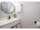 Elegant powder room featuring modern vanity with white countertop, stylish mirror and updated fixtures at 10945 Winterbourne Ct, Charlotte, NC 28277