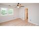 Comfortable bedroom with light colored flooring and a pair of bright windows at 10945 Winterbourne Ct, Charlotte, NC 28277