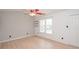 Bright bedroom with natural light, ceiling fan, closet, and updated flooring at 10945 Winterbourne Ct, Charlotte, NC 28277