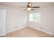 Cozy bedroom featuring light-colored flooring, a ceiling fan, and a bright window at 10945 Winterbourne Ct, Charlotte, NC 28277