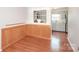 Dining room with wood wainscoting and view into kitchen pass-through window at 10945 Winterbourne Ct, Charlotte, NC 28277