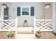 Inviting home entrance with white fence, flower pots, and welcome sign at 10945 Winterbourne Ct, Charlotte, NC 28277