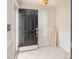 Inviting entryway with a black door, tiled floor, welcome sign, and natural light streaming through the window at 10945 Winterbourne Ct, Charlotte, NC 28277
