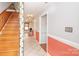 Inviting hallway with staircase and tile flooring, leading to various rooms in the house at 10945 Winterbourne Ct, Charlotte, NC 28277