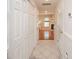 Hallway with closet doors, tile floors, and view into living room with a fireplace at 10945 Winterbourne Ct, Charlotte, NC 28277