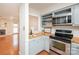Kitchen with stainless appliances, butcher block counters, and pass-through to an open living area at 10945 Winterbourne Ct, Charlotte, NC 28277