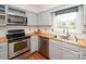 Well-lit kitchen featuring stainless appliances, light blue cabinets, and wood countertops by a window at 10945 Winterbourne Ct, Charlotte, NC 28277