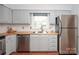 Well-lit kitchen with stainless steel appliances and bright white subway tile backsplash at 10945 Winterbourne Ct, Charlotte, NC 28277