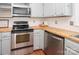 Kitchen showcasing stainless steel appliances, white subway tile backsplash and butcher block countertops at 10945 Winterbourne Ct, Charlotte, NC 28277