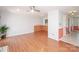 Open living area with wood floors, access to kitchen, and a ceiling fan at 10945 Winterbourne Ct, Charlotte, NC 28277