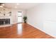 Cozy living room featuring a brick fireplace, built-in shelving, and hardwood flooring at 10945 Winterbourne Ct, Charlotte, NC 28277