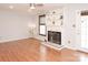 Bright living room with hardwood floors, a fireplace, and built-in shelving and a door to the outside at 10945 Winterbourne Ct, Charlotte, NC 28277