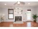 Charming living room with hardwood floors, fireplace, built-in shelving, and a ceiling fan for comfort at 10945 Winterbourne Ct, Charlotte, NC 28277