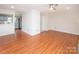 Spacious living room featuring hardwood floors and open floor plan with neutral paint at 10945 Winterbourne Ct, Charlotte, NC 28277