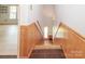 Traditional staircase with wood and stone accents, leading to the upper or lower levels at 10945 Winterbourne Ct, Charlotte, NC 28277
