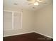 Cozy bedroom featuring a large window, ceiling fan and hardwood floors at 11107 Lions Mane St, Charlotte, NC 28273