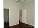 A bedroom featuring a bathroom door and a walk-in closet door, enhancing the room's functionality at 11107 Lions Mane St, Charlotte, NC 28273