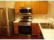 Stylish kitchen features stainless steel appliances, wood cabinets, and white countertops at 11107 Lions Mane St, Charlotte, NC 28273