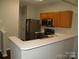 Modern kitchen boasts stainless steel appliances, ample counter space and wood cabinets at 11107 Lions Mane St, Charlotte, NC 28273