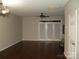 Spacious living room featuring hardwood floors, ceiling fan and a door to the backyard at 11107 Lions Mane St, Charlotte, NC 28273