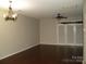 Open living room with hardwood floors, modern lighting, and a large glass door at 11107 Lions Mane St, Charlotte, NC 28273