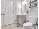 Clean bathroom featuring a gray vanity with a sink, toilet, and neutral tiled floor at 124 Cedarcroft Dr, Mooresville, NC 28115