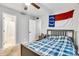 Cozy bedroom with a bed, North Carolina flag decor, ceiling fan and ensuite bath at 124 Cedarcroft Dr, Mooresville, NC 28115