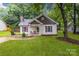 Charming single-story home with a lovely front yard, porch, and traditional design elements at 124 Cedarcroft Dr, Mooresville, NC 28115