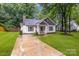 Exterior front view of single-story home featuring a well-kept lawn and driveway at 124 Cedarcroft Dr, Mooresville, NC 28115