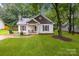 Charming one-story home with well-manicured lawn and cozy front porch at 124 Cedarcroft Dr, Mooresville, NC 28115