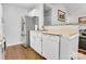Practical kitchen layout with white cabinets, stainless steel refrigerator, and laminate flooring at 124 Cedarcroft Dr, Mooresville, NC 28115