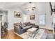 Bright and airy living room featuring hardwood floors, a ceiling fan, and natural light at 124 Cedarcroft Dr, Mooresville, NC 28115
